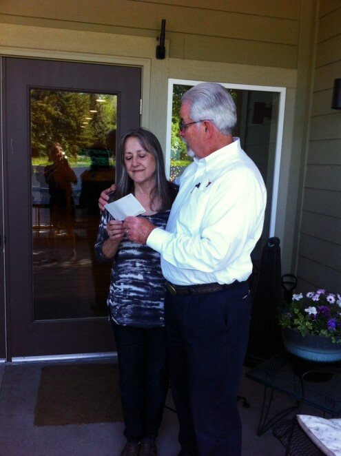 David Richardson delivering a check to Deb Ploetz